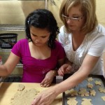 Tina baking cookies with Santos